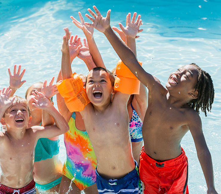 Group of children enjoying water games during Bahia Resort Hotel's Summer Activities in Mission Bay, San Diego, CA.