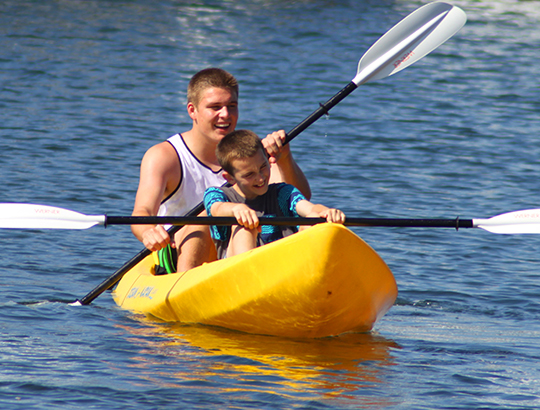 Brothers kayaking on Mission Bay with watercraft rented from Action Sport Rental