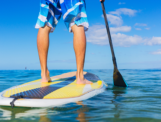 Stand-up paddle boarding on SUPs rented from Action Sport Rental at the Bahia Resort Hotel