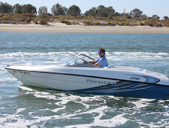 Bahia Resort Hotel guest driving a power boat from Action Sport Rental on Mission Bay