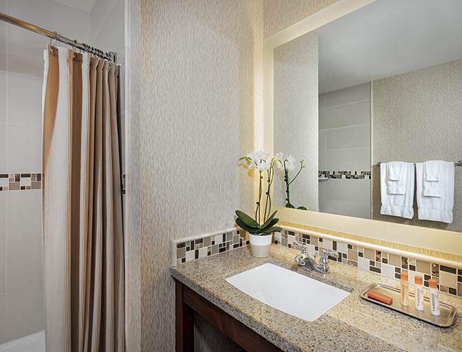 Bay View bathroom with a sink and shower at the Bahia Resort Hotel in Mission Beach, San Diego