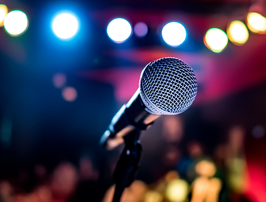 Microphone on stand with crowd in background