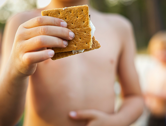 Young boy holding a s'more on Mission Bay