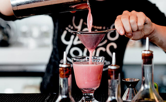 Bartender making a cocktail at a rooftop bar in Mission Bay