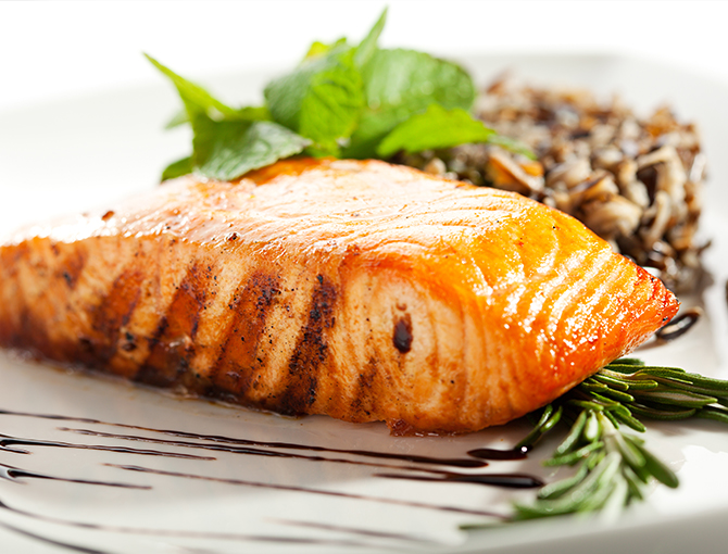 Fish, wild rice and vegetables on a plate