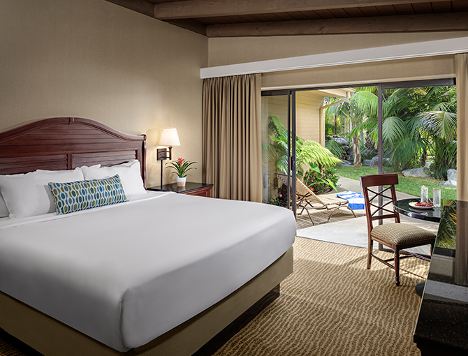 Garden View room with a queen bed at the Bahia Resort Hotel in Mission Beach, San Diego