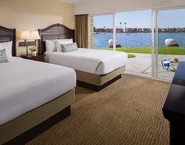 Bayfront Room with two queen beds and a view of the patio and Mission Bay at the Bahia Resort Hotel in Mission Beach, San Diego 