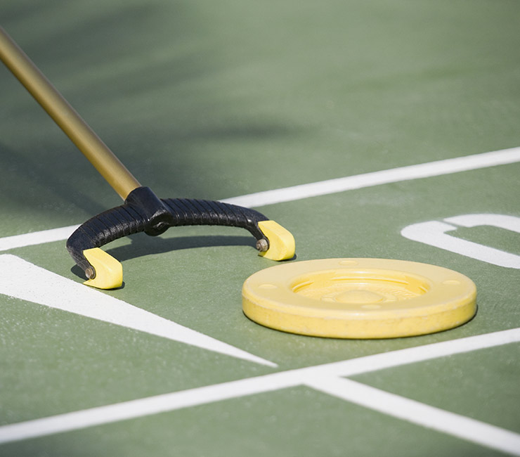 Playing a round of shuffleboard at the Bahia Resort Hotel’s lush gardens