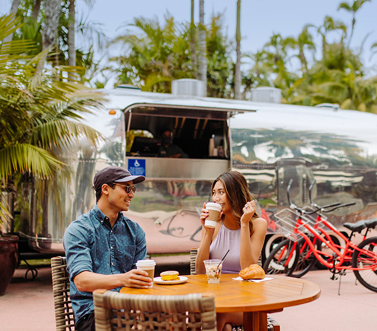 A couple enjoying a meal by the Air Stream Grab-n-Go at the Bahia Resort Hotel in Mission Bay, San Diego