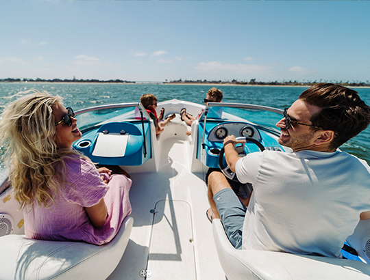 Bahia Resort Hotel guest driving a power boat from Action Sport Rental on Mission Bay