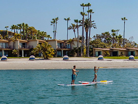 Stand-up paddle boarding on SUPs rented from Action Sport Rental at the Bahia Resort Hotel