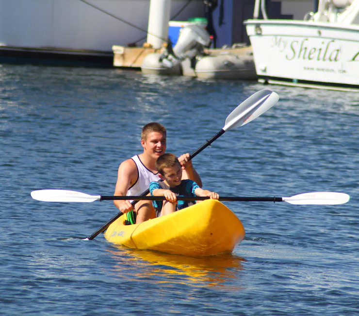 Brothers kayaking on Mission Bay with watercraft rented from Action Sport Rental