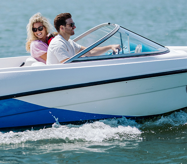 Couple enjoying riding a motor boat on Mission, Bay San Diego