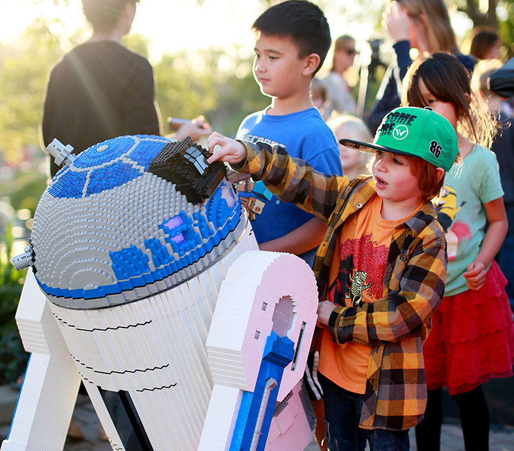 Boy engaging with Lego creation at LEGOLAND California