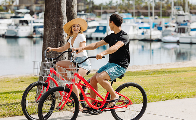 Couple biking on the Mission Bay boardwalk