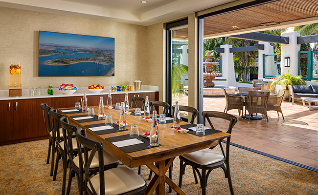 The new Fountain Room offering a versatile boardroom setting looking out on the updated Fountain Patio ideal for a charming open-air event at the Bahia Resort Hotel in San Diego.