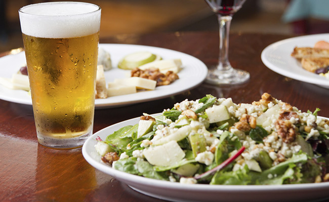 Beer Close up and delicious dinner salad on a plate