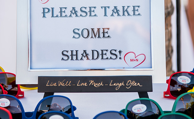 Sign at Beach Wedding encouraging guests to take sunglasses