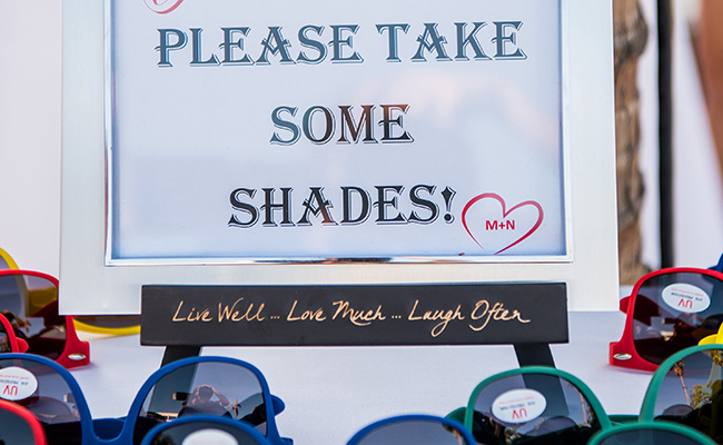 Sign at Beach Wedding encouraging guests to take sunglasses