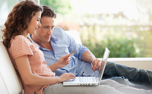 Couple sitting on chair working on wedding site