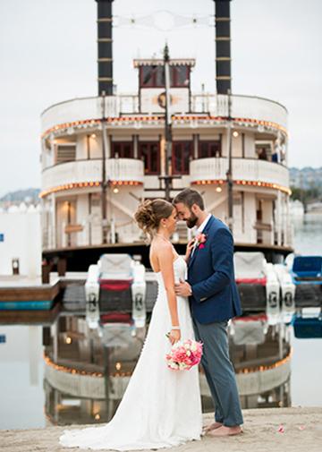 Wedding couple embracing in front of the William D. Evans on Mission Bay