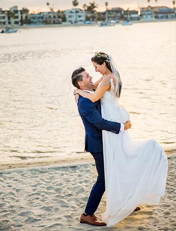 Wedding couple embracing on the private beach at the Bahia Resort Hotel