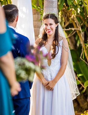 Bride smiling at her groom at their San Diego destination wedding at the Bahia Resort Hotel.