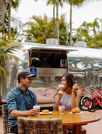 Couple enjoying coffee at the Airstream Grab-n-Go at Bahia Resort Hotel