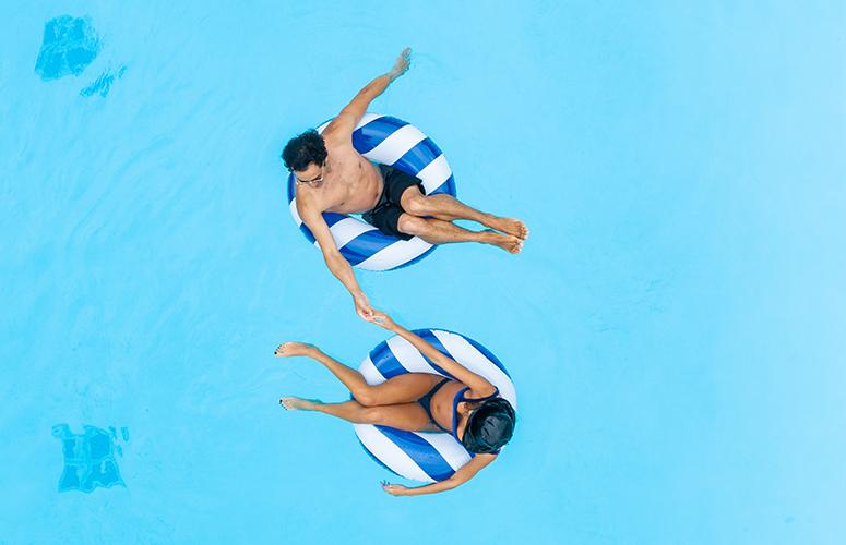 Couple in tubes enjoying pool at Bahia Resort Hotel in San Diego