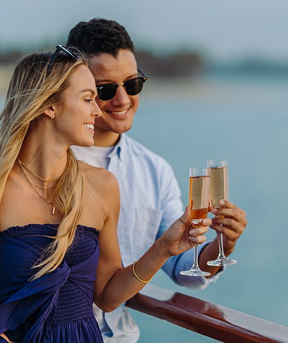 A couple toasting with bubbly on the Bahia Belle during a private boat event in San Diego on Mission Bay.